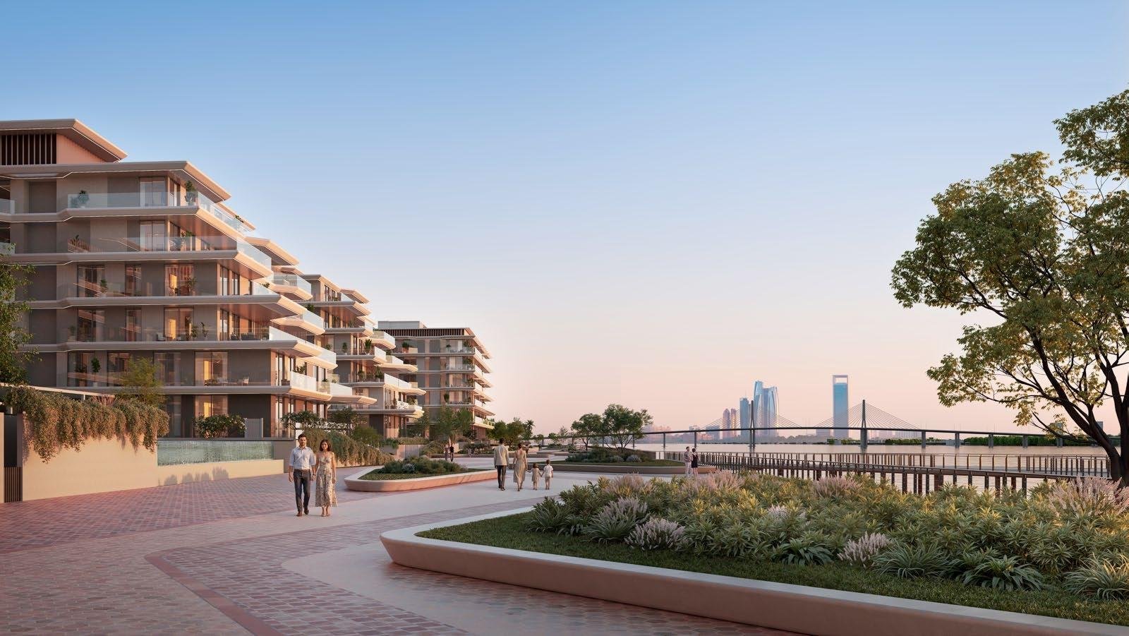 Residents enjoying rooftop infinity pool at Bashayer Residences with panoramic skyline and Abu Dhabi waterfront views